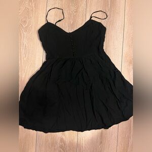 Black express dress with pockets and button detail in size S